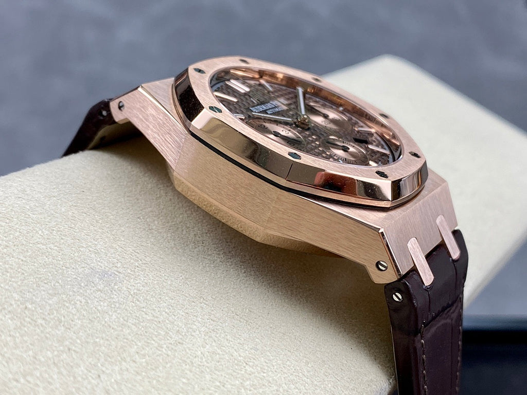 Rose gold watch case angled view with metal bracelet pins and dark leather strap