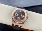 Rose gold chronograph watch with dark dial and brown leather strap, angled front shot