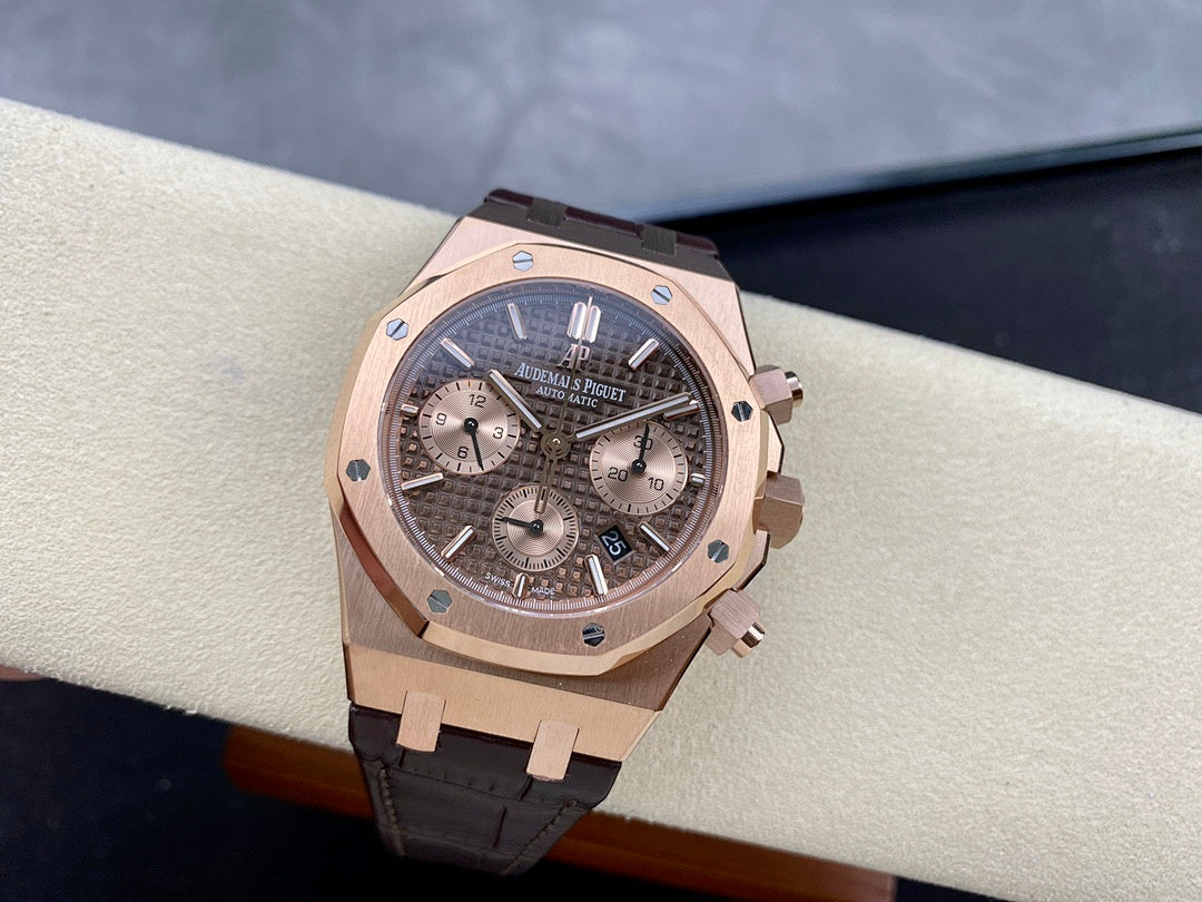 Rose gold chronograph watch with dark dial and brown leather strap, angled front shot