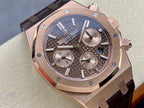 Rose gold luxury chronograph watch with dark patterned dial and leather strap, angled front