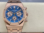 Blue dial chronograph wristwatch with rose-gold case, crown, and integrated bracelet