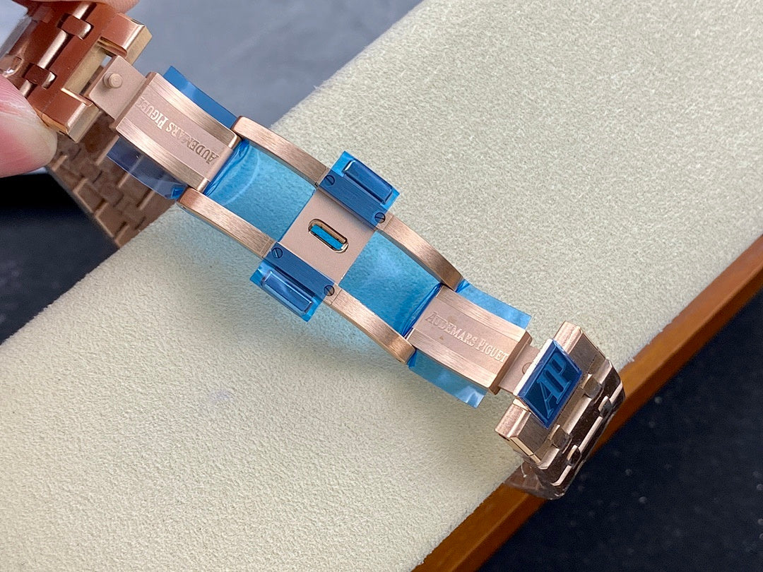Rose-gold metal bracelet links with blue accents on a chronograph wristwatch