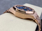 Rose-gold chronograph wristwatch case with blue dial and textured bezel detail