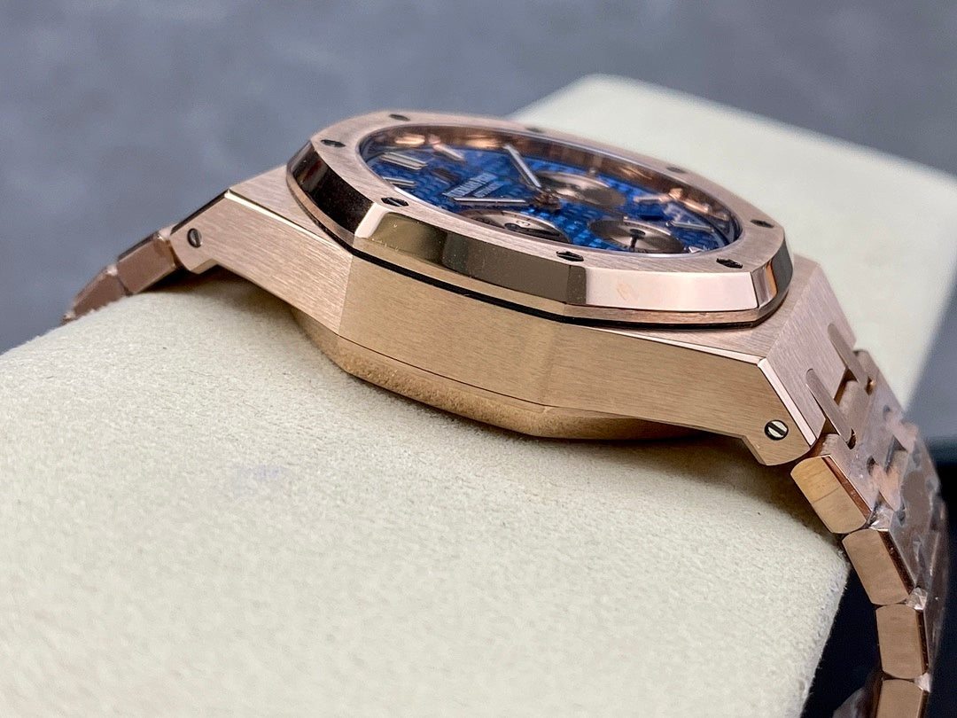 Rose-gold chronograph wristwatch case with blue dial and textured bezel detail