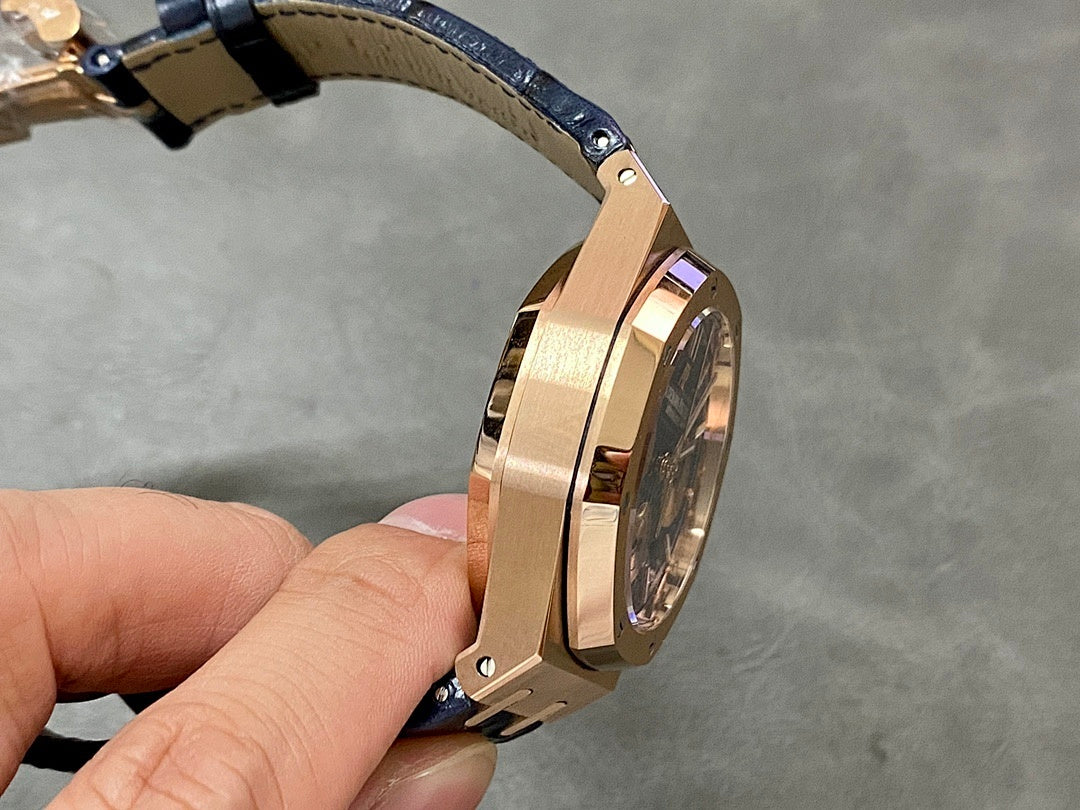 Audemars Piguet Royal Oak watch, angled side view, gold case with blue strap lugs