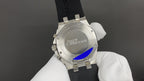 Stainless steel caseback Audemars Piguet watch on black rubber strap.