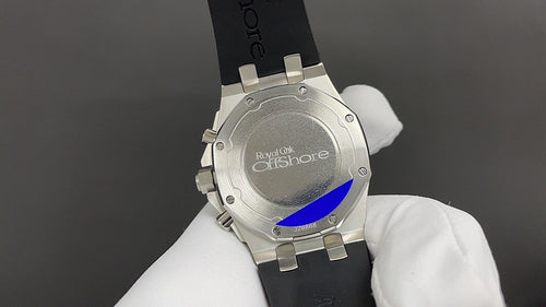 Stainless steel caseback Audemars Piguet watch on black rubber strap.