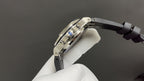 Stainless steel watch clasp and strap hardware, black rubber band.