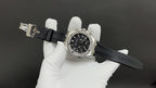 Stainless steel Audemars Piguet watch, diamond bezel, black dial on black rubber strap.