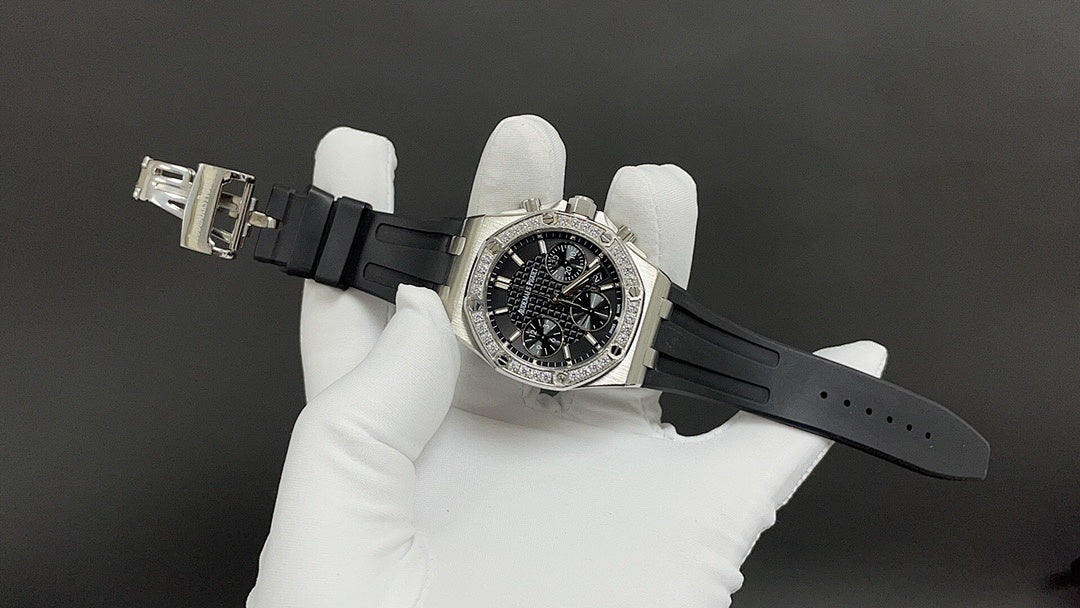 Stainless steel Audemars Piguet watch, diamond bezel, black dial on black rubber strap.