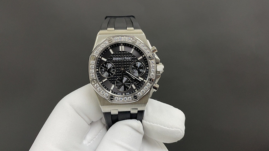 Stainless steel Audemars Piguet watch, black chronograph dial, diamond bezel, right-side view.