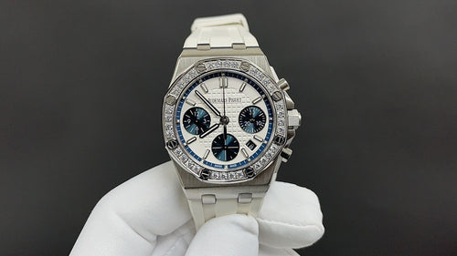 Audemars Piguet watch with silver bezel, blue dial, and white rubber strap