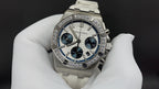 Audemars Piguet watch with diamond bezel, blue subdials, and white rubber strap