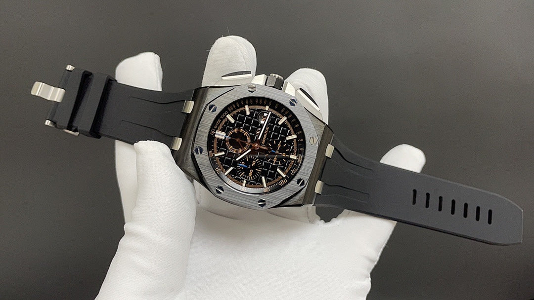 Audemars Piguet wristwatch on dark silicone strap, black dial with gold accents