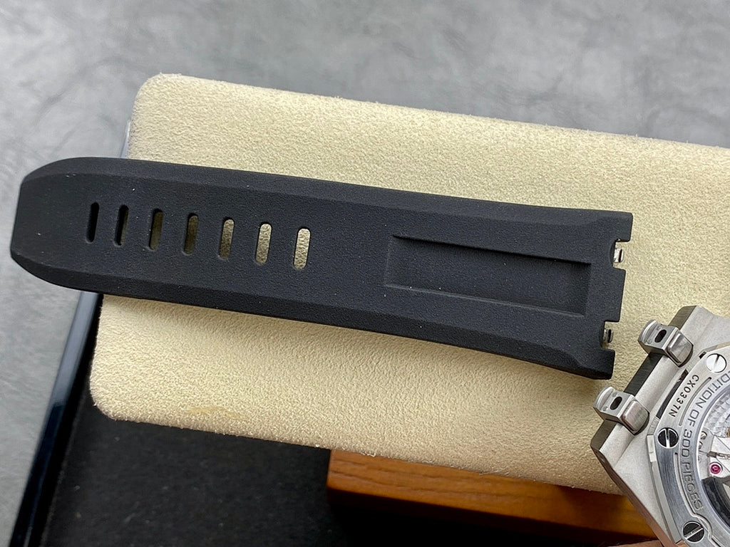 Dark rubber watch strap segment with metal clasp and adjustment holes