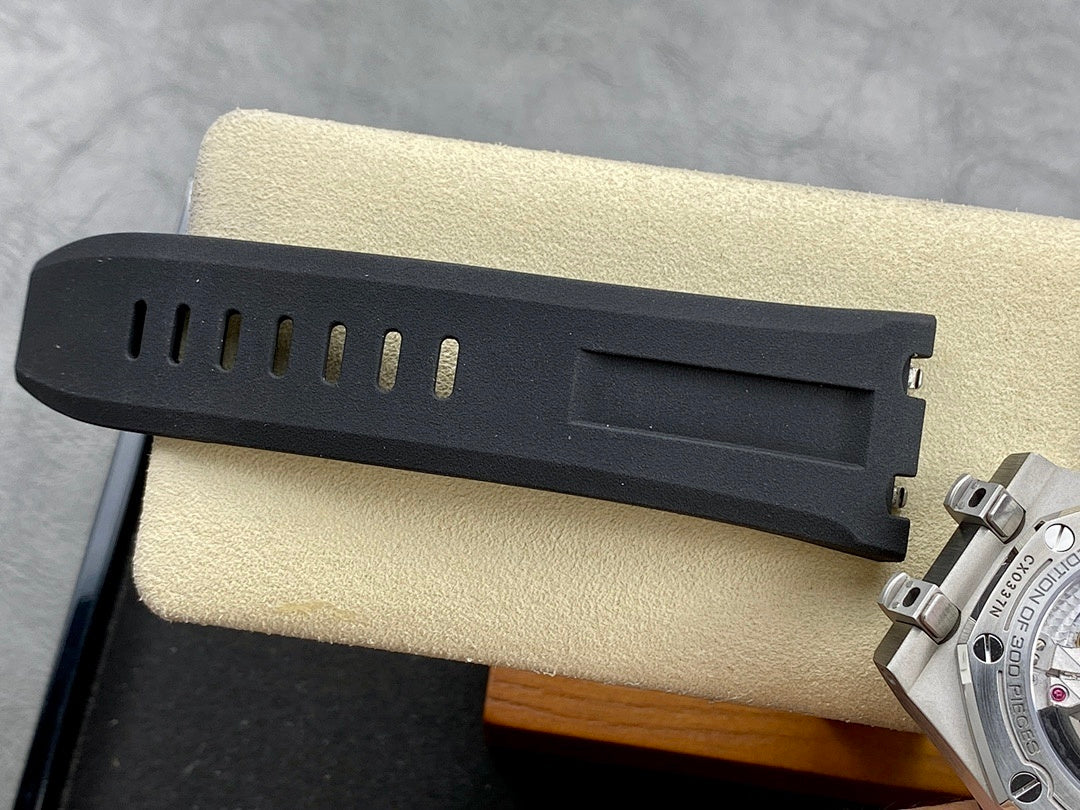 Dark rubber watch strap segment with metal clasp and adjustment holes