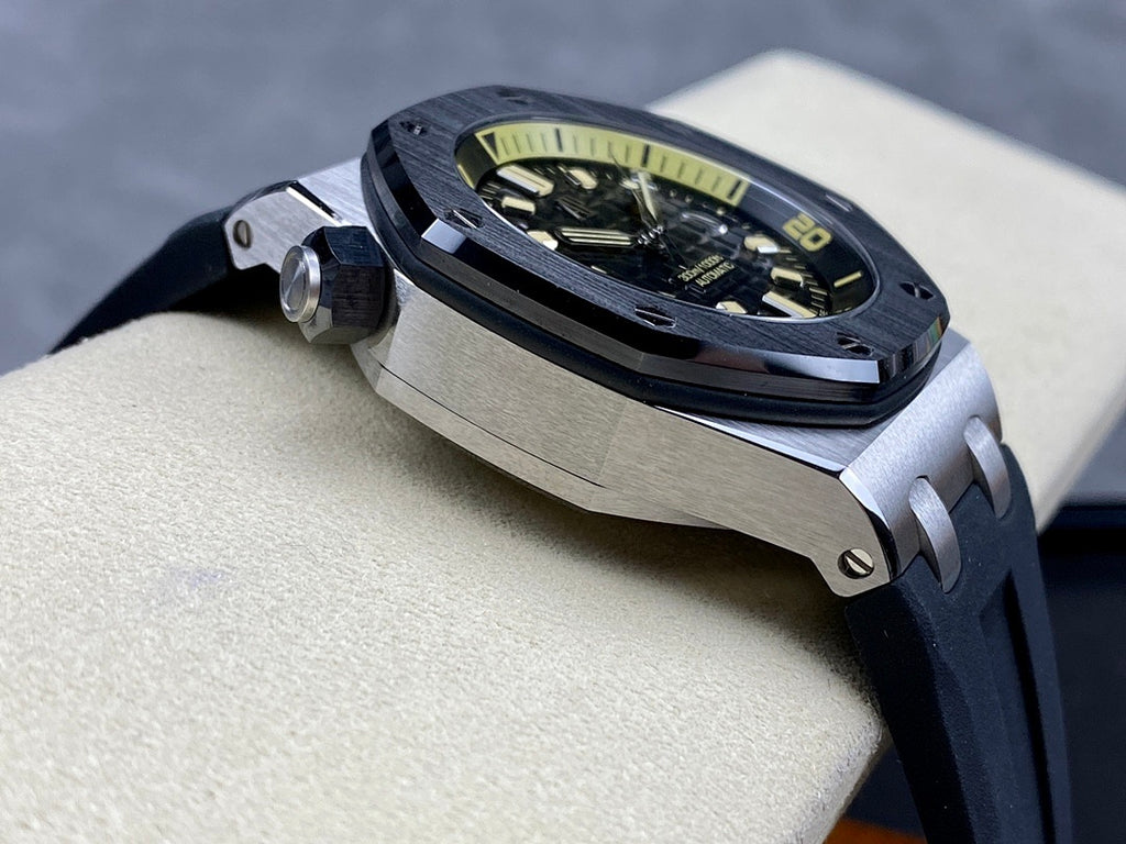 Luxury sports watch with dark dial and dark rubber strap shown at a three-quarter angle