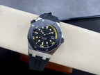 Luxury sports watch with dark dial, yellow accents, and dark rubber strap
