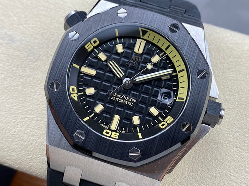 Luxury sports watch with dark dial, yellow markers, and dark rubber strap on display