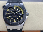 Luxury sports watch with dark dial, yellow markers, and dark rubber strap, straight-on view