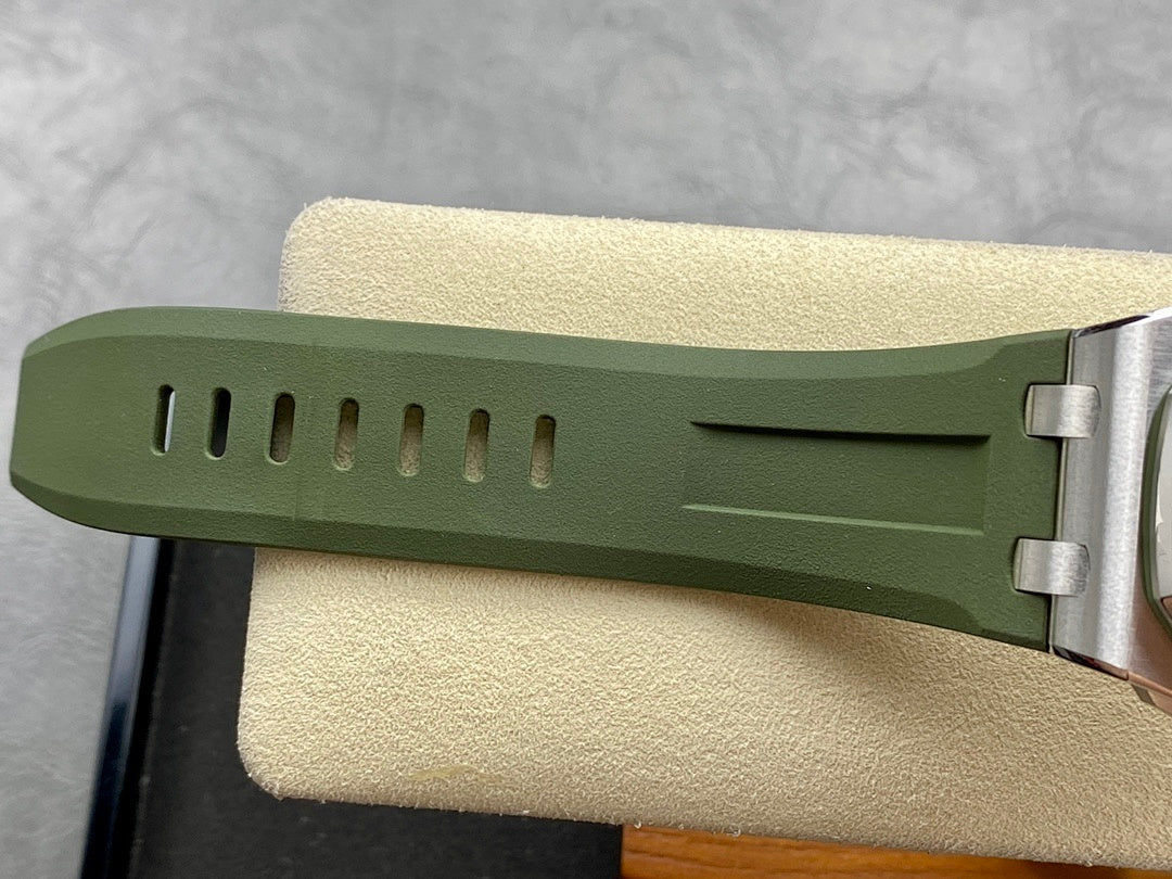 Green silicone watch strap segment with ventilation holes and metal buckle hardware