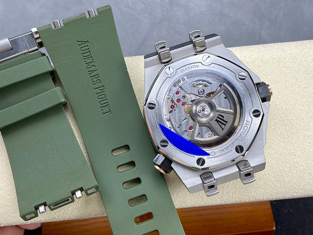 Watch case back view with exposed mechanical movement on a green strap