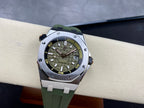 Sports watch on the wrist with green dial, luminous markers, metal bezel, green rubber strap