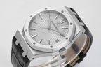 Audemars Piguet watch close-up of textured light dial, silver hands, black bezel