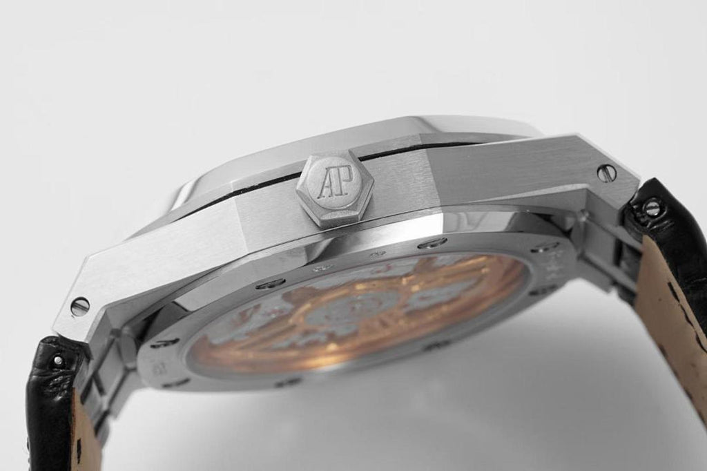Stainless steel wristwatch case side view with open back and inner components visible