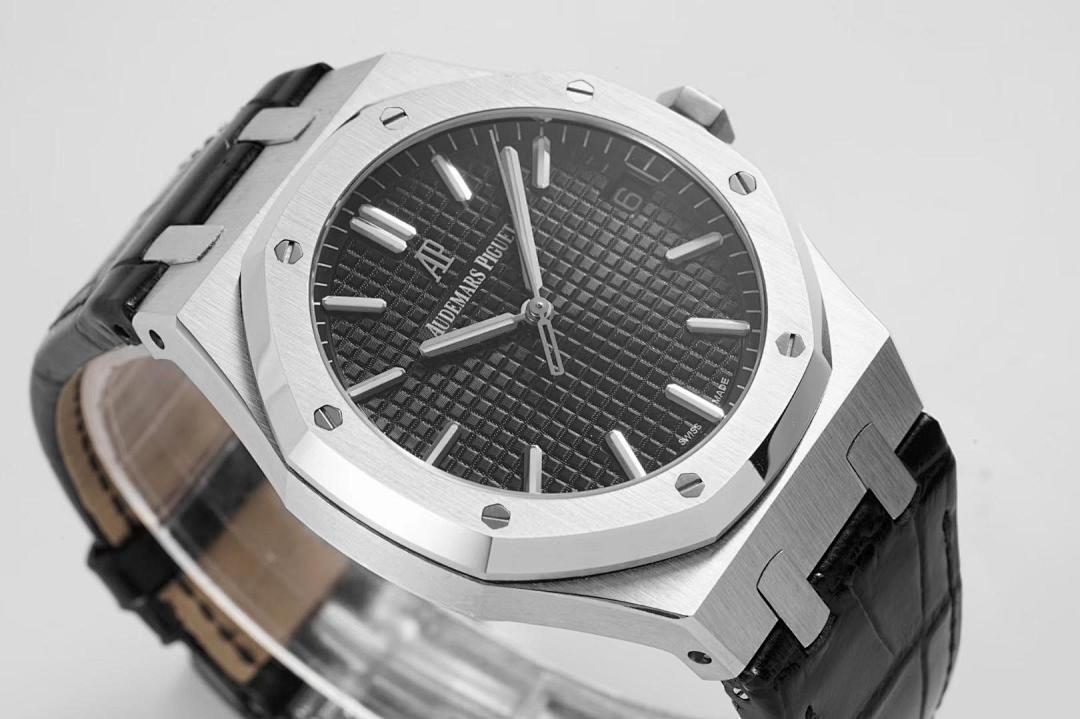 Stainless steel wristwatch close-up with black dial and black leather strap