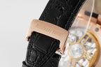 Audemars Piguet watch strap clasp in rose gold on black leather band.