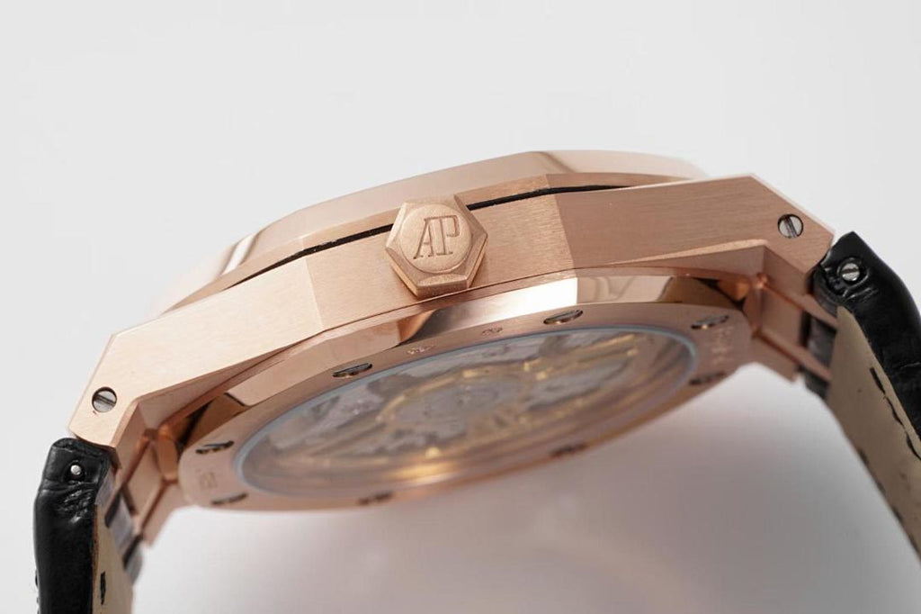 Audemars Piguet watch case top with AP emblem, rose gold finish, and black leather strap.