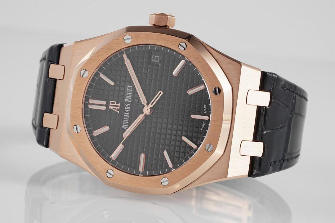 Audemars Piguet Royal Oak watch with rose gold case, dark dial, and black leather strap.