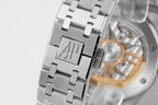 Stainless steel watch caseback with engraved emblem and linked metal bracelet