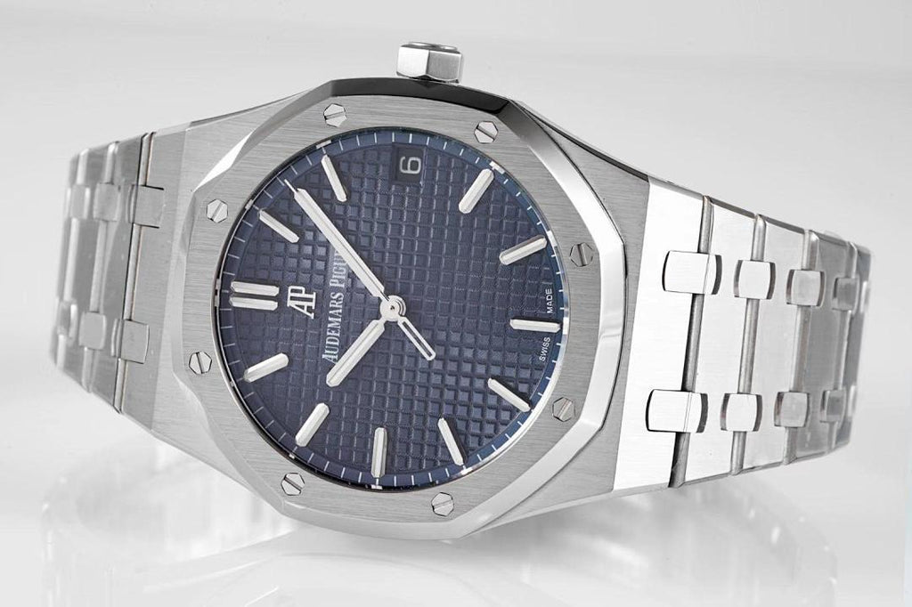 Stainless steel watch with blue dial and metal bracelet, angled top view