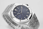Stainless steel watch with blue dial and metal bracelet, three-quarter close-up