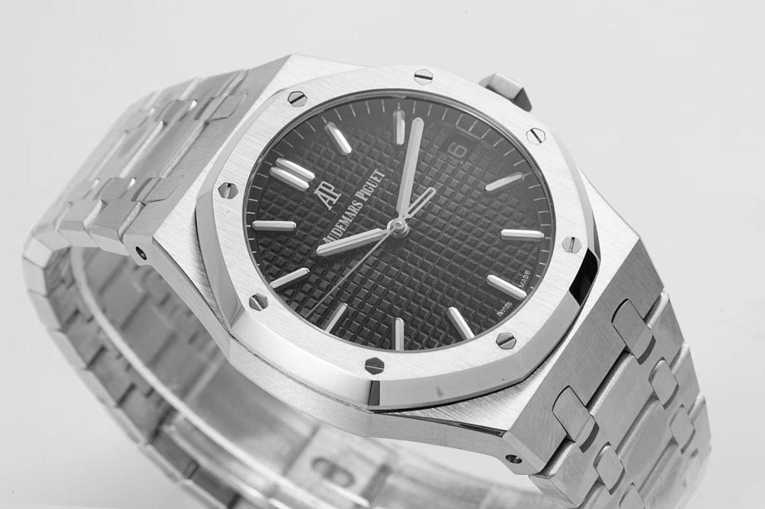 Men’s wristwatch close-up of black dial and silver bezel with date window