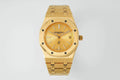 Gold-tone Audemars Piguet watch with textured champagne dial and date at 3