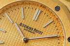 Gold-tone dial close-up showing 'AUDEMARS PIGUET' Automatic and baton markers