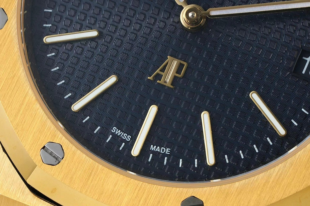 Dark blue Audemars Piguet dial with gold hands, markers, and 'SWISS MADE'