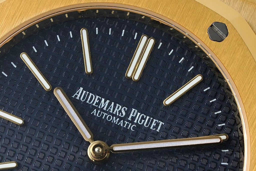 Dark blue Audemars Piguet dial with gold hour markers and 'AUTOMATIC' text