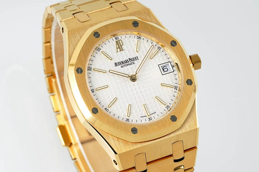 Gold-tone wristwatch front with white dial and octagonal bezel, angled view