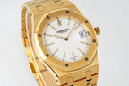 Gold-tone wristwatch front with white dial and octagonal bezel, angled view