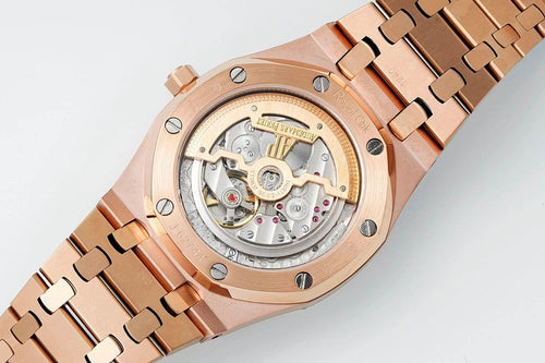 Rose gold-tone wristwatch close-up showing dark dial window and rose bracelet links.