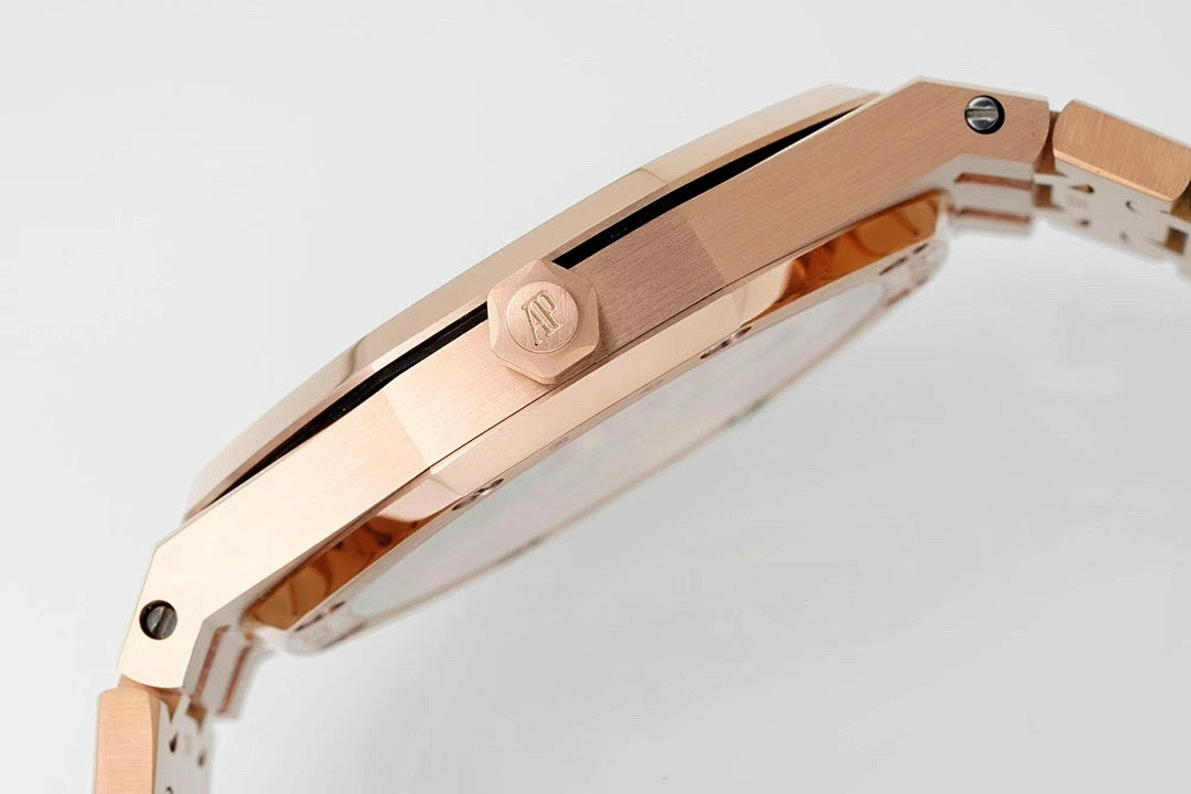 Rose gold-tone wristwatch case side with crown detail and metal link bracelet.
