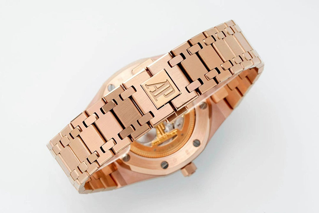 Rose gold-tone wristwatch case back view with metal link bracelet and exposed movement.