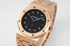 Audemars Piguet rose gold watch with black dial and date window, angled front