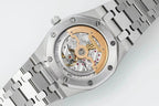 Watch with visible mechanical movement through glass caseback, steel bracelet