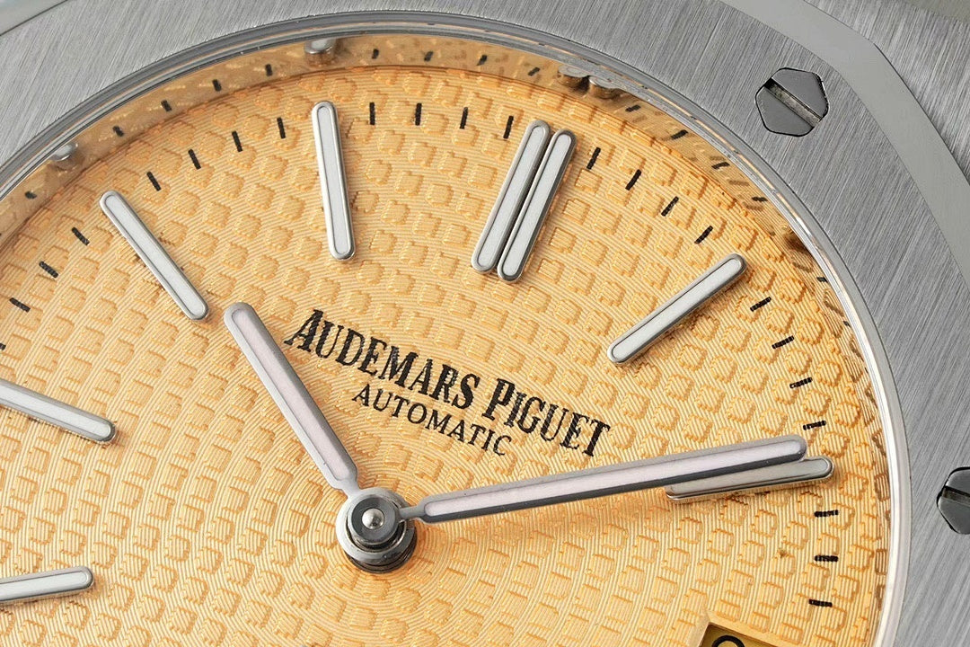 Champagne dial close-up with Automatics text, baton markers, silver hour hands