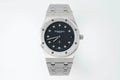 Audemars Piguet steel wristwatch with black dial, octagonal bezel, and link bracelet